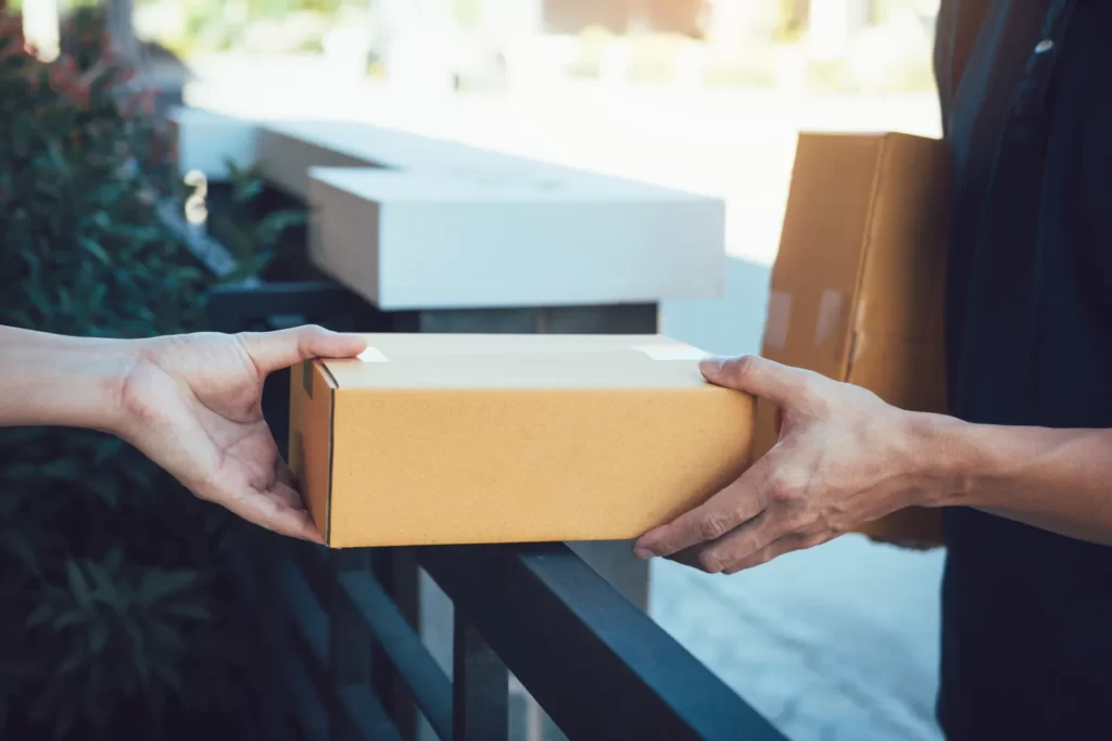 person receiving box delivery at urban home utc