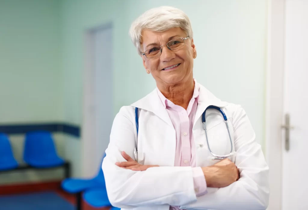 smiling woman doctor poses confidently in office utc
